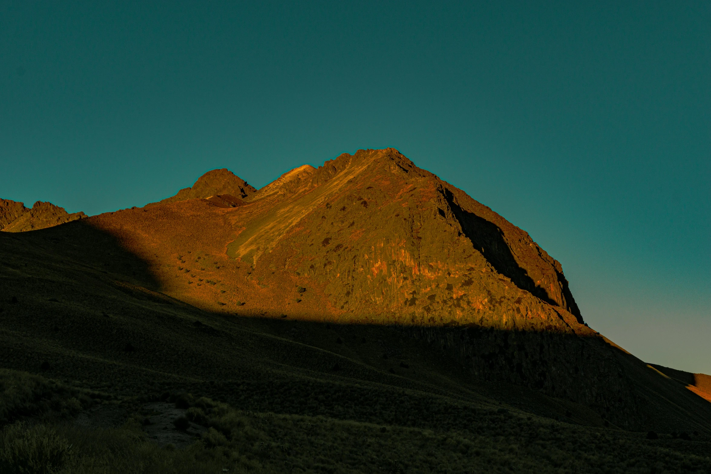 the shadow of the mountains on a clear day