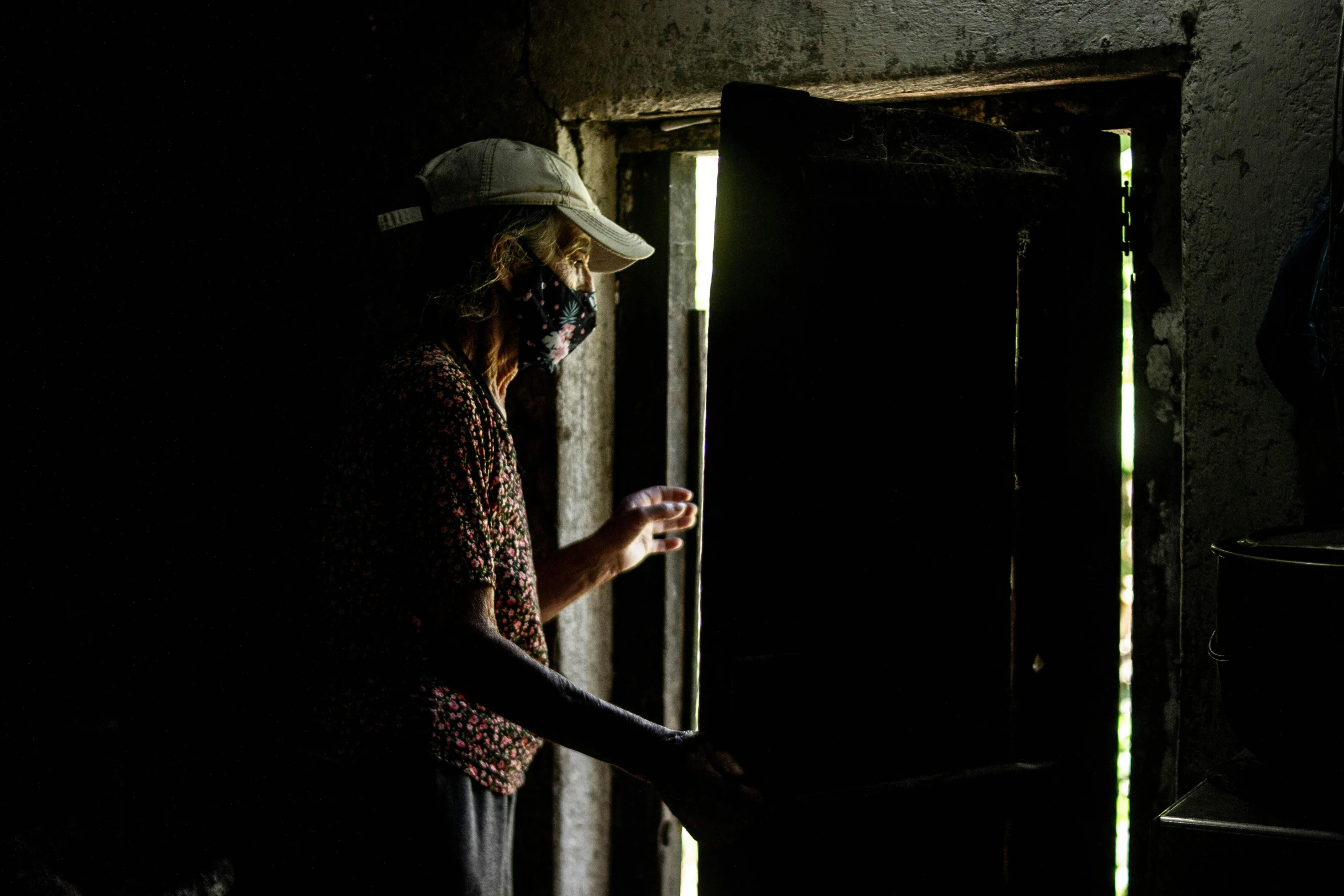 the man has on a white hat and looks at his phone