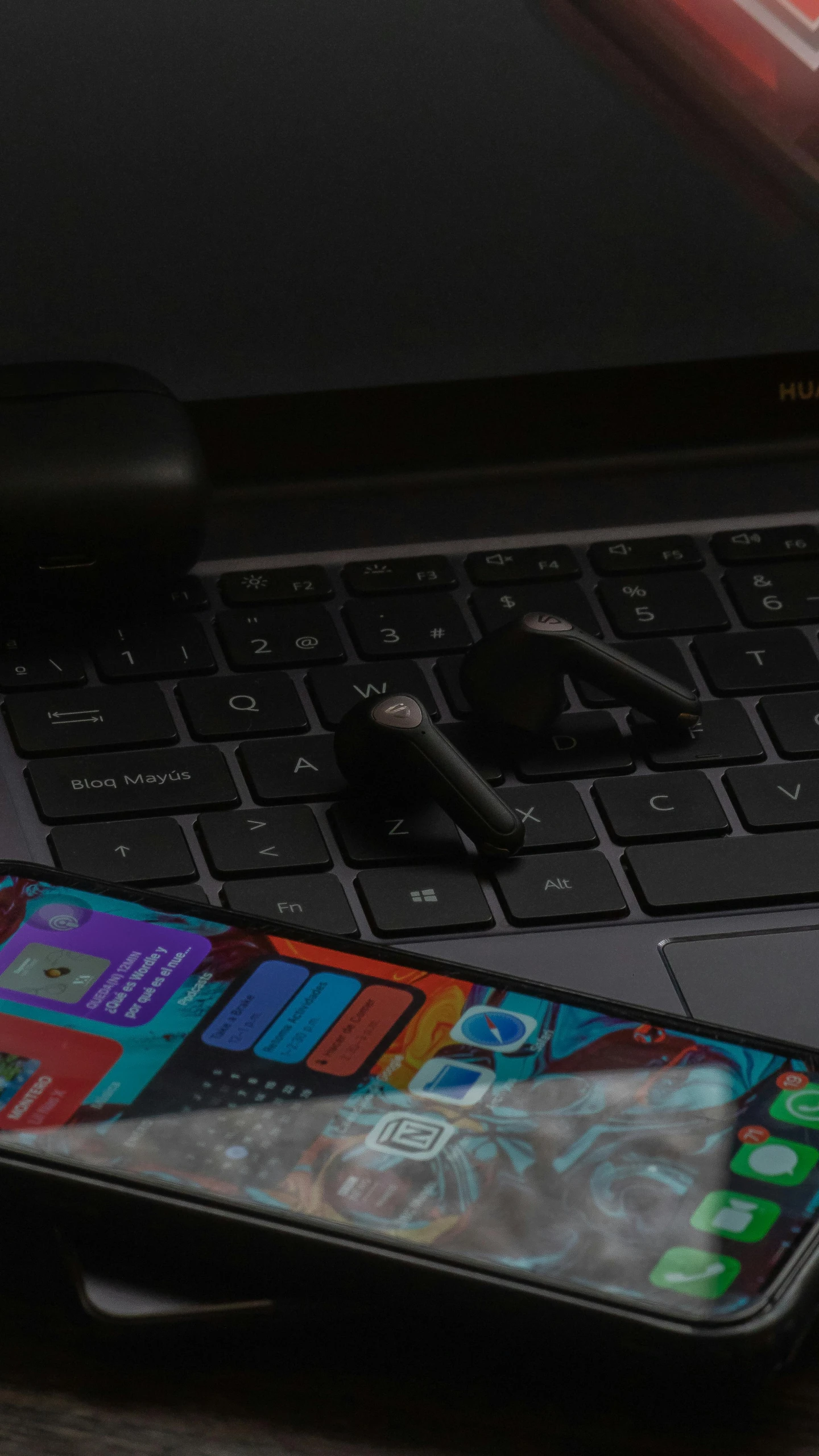 a close up s of a cellphone beside a laptop