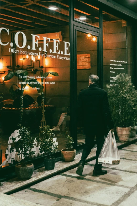 a man walks down the street next to a shop