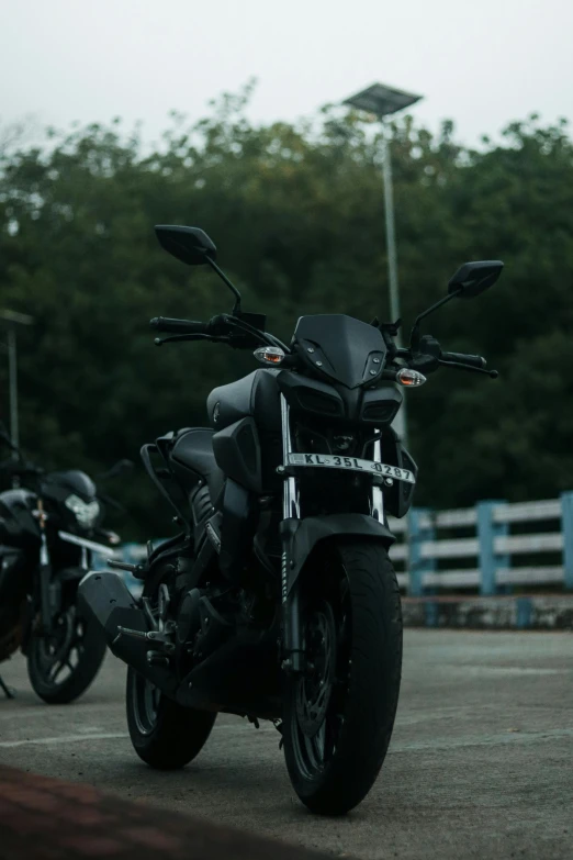 the motorcycle is parked next to another motor cycle