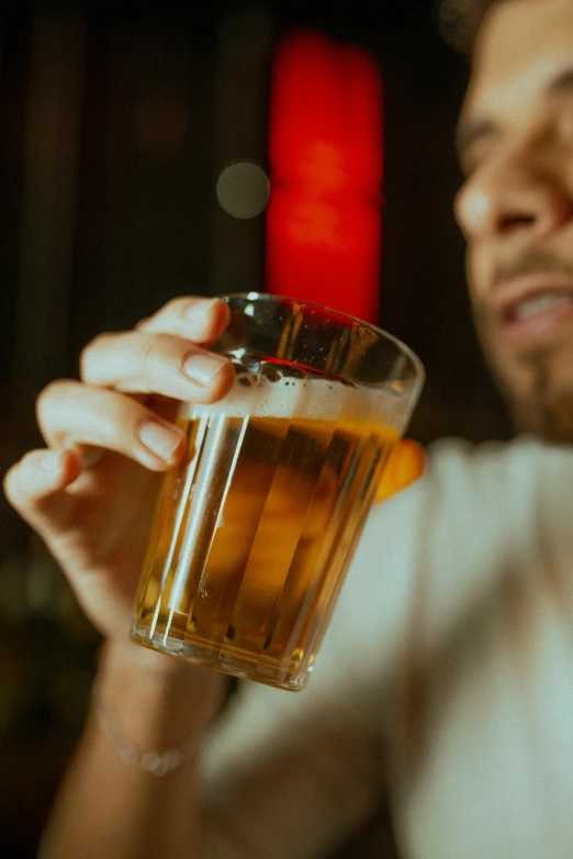 the man is enjoying his beer in the glass