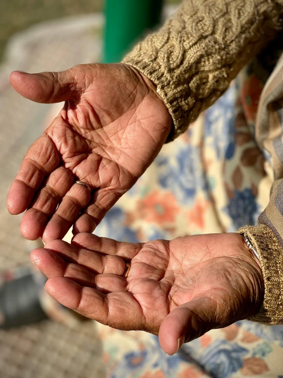 a woman in celets is holding out her hand