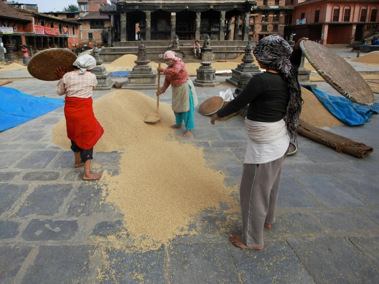 a group of people standing in front of some buildings