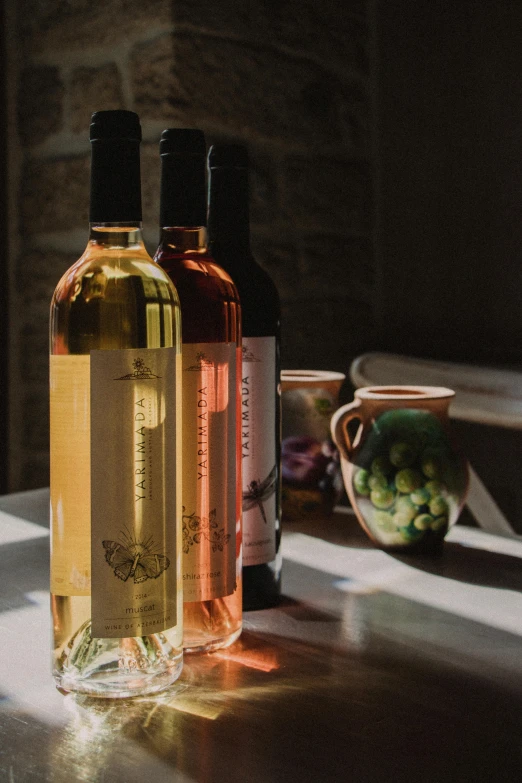 three different bottles of wine sitting on a table