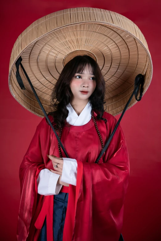 a woman in red clothing with an asian hat