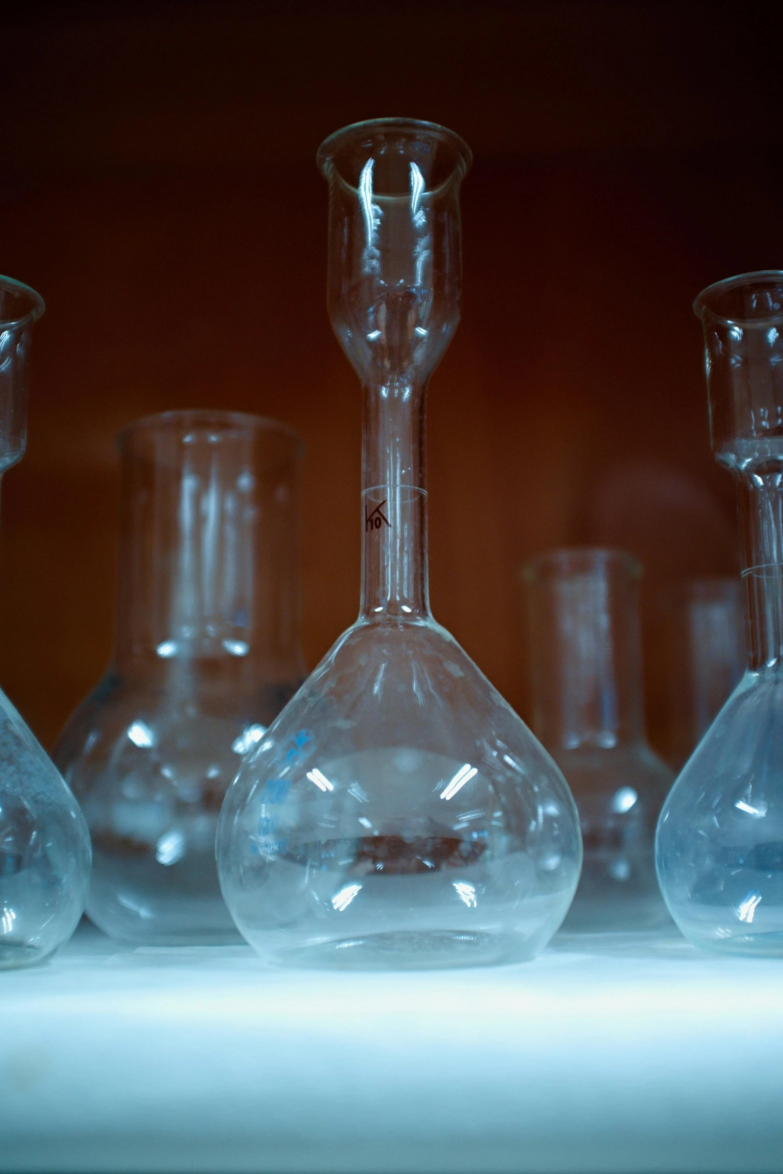 some glass flasks are sitting on a counter