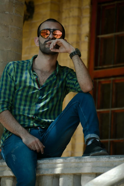 a man wearing sunglasses is posing for a po