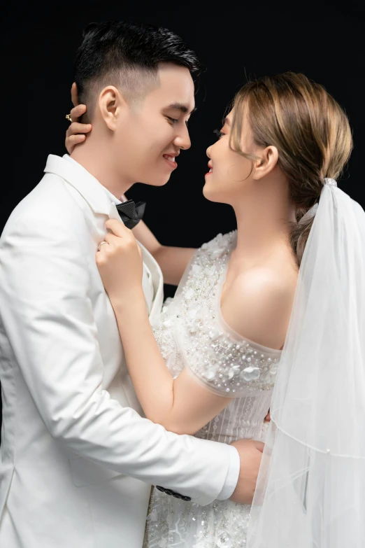 a couple kissing in the studio on their wedding day