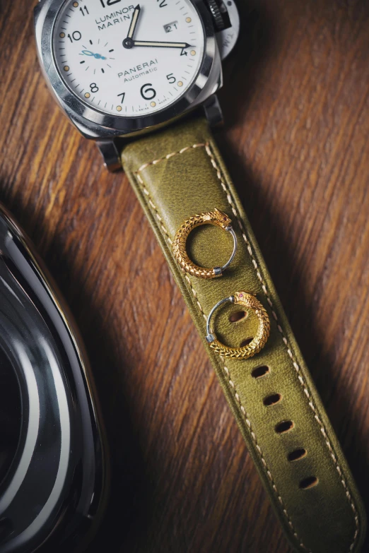 a leather watch strap and watch with ring