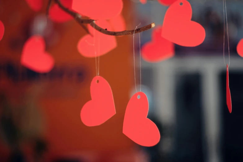 red heart cards hanging in the wind