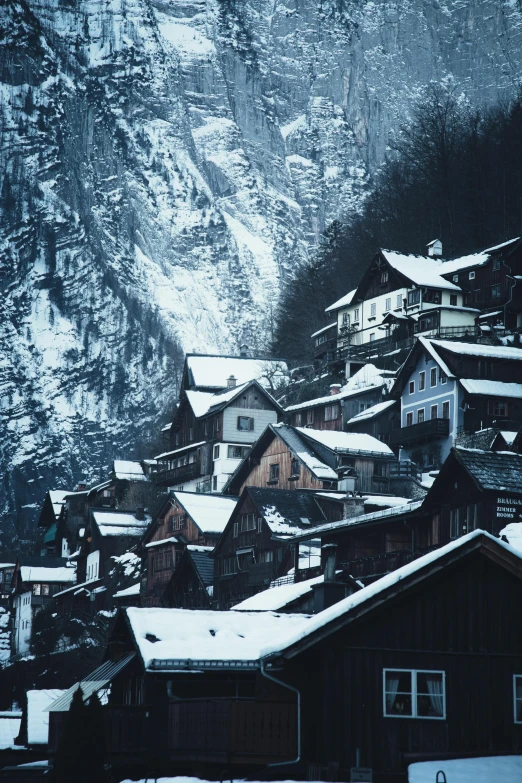 snow covered village in front of the mountains