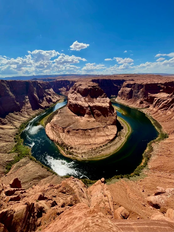 canyon in the desert, with a river flowing between two large hills