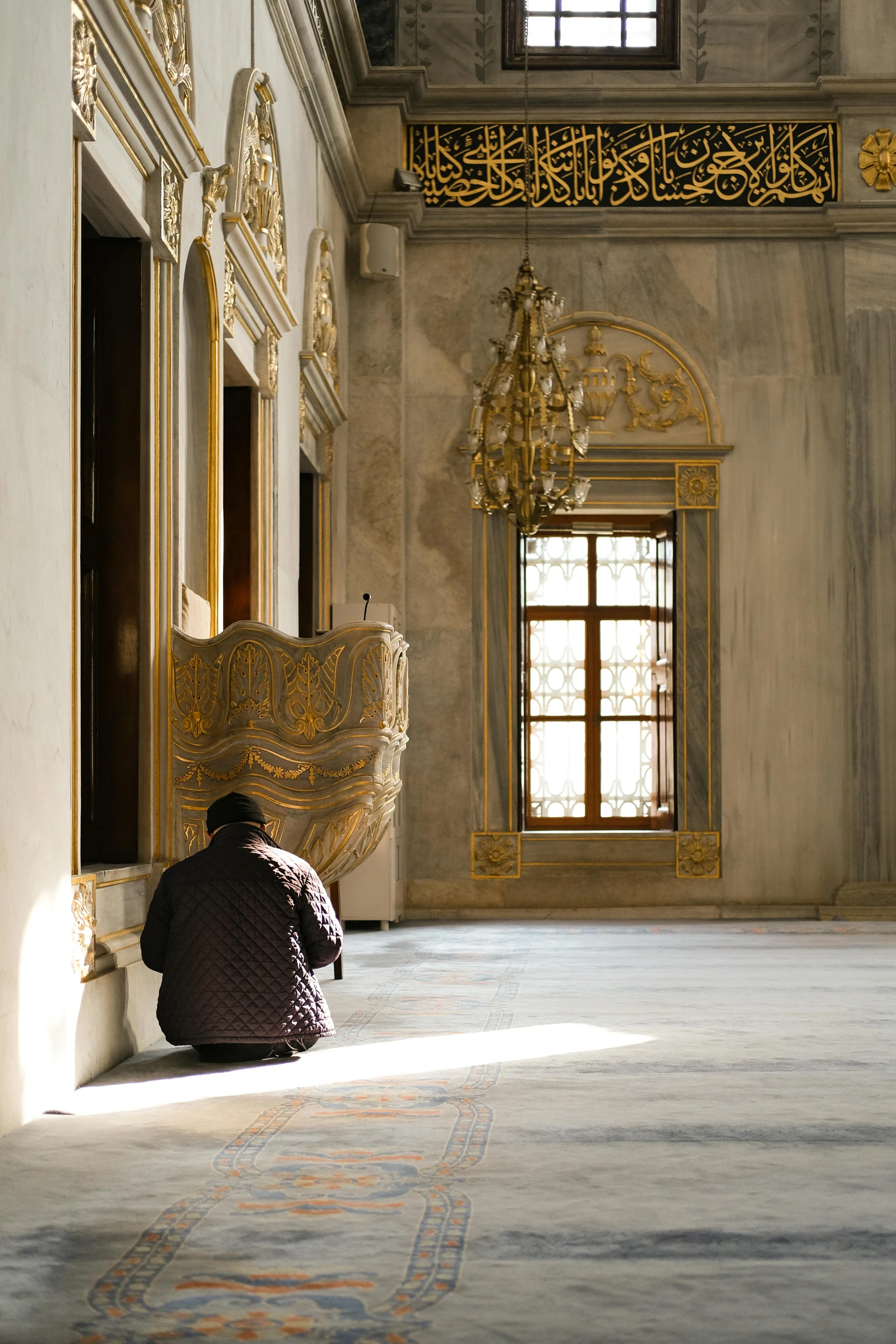 a person is kneeling down and looking out the window