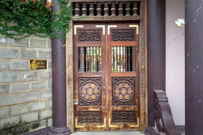 the wooden door has intricate ironwork designs