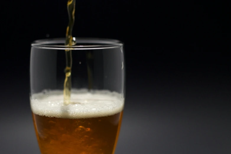 the liquid is poured into a glass on the table