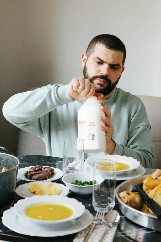 a man is sitting at the table with his food and drink