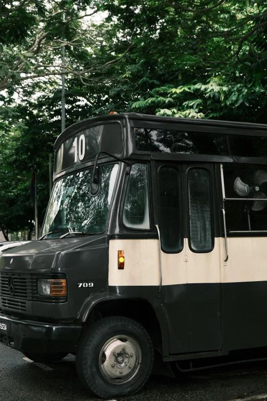 an old fashioned bus sitting in the middle of a road