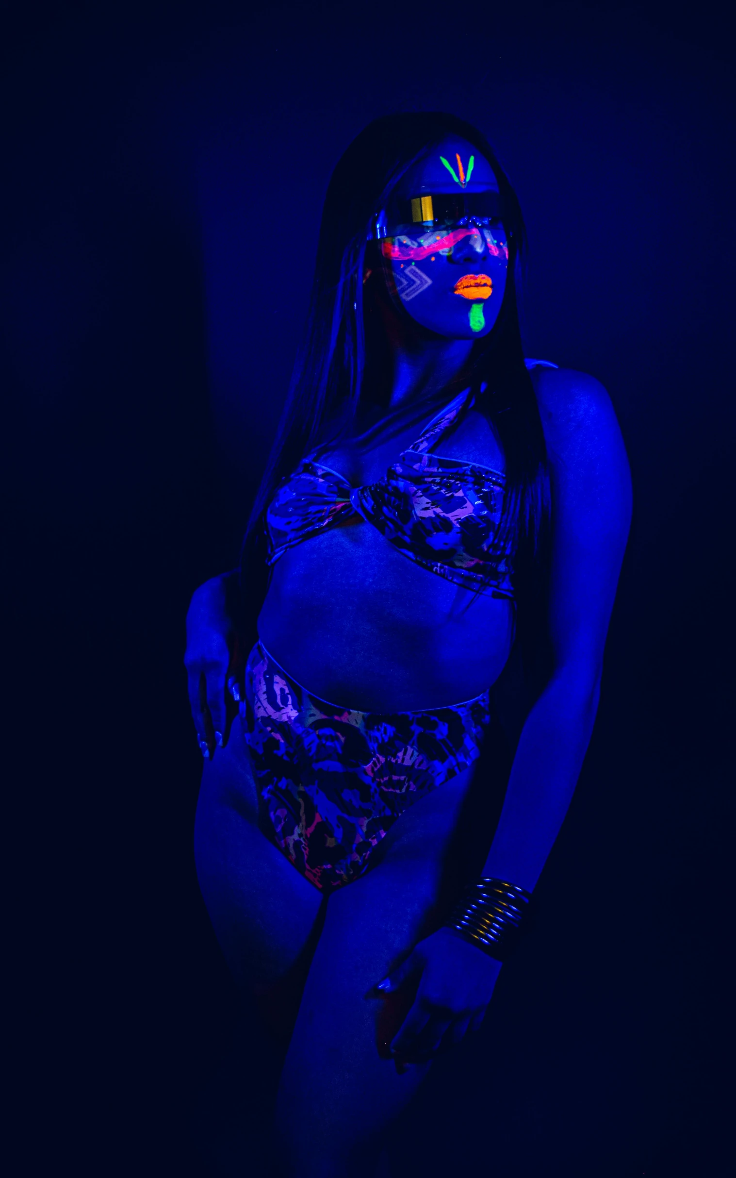 a woman in a swimsuit with neon glasses