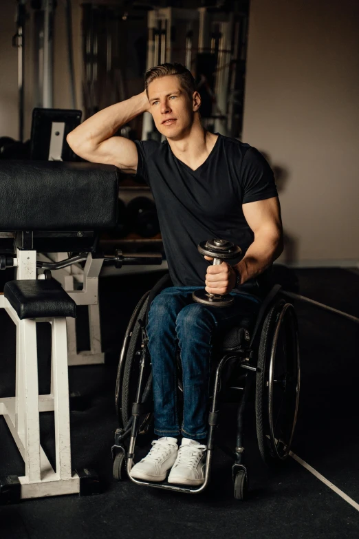 a man in a wheelchair sitting in front of a machine