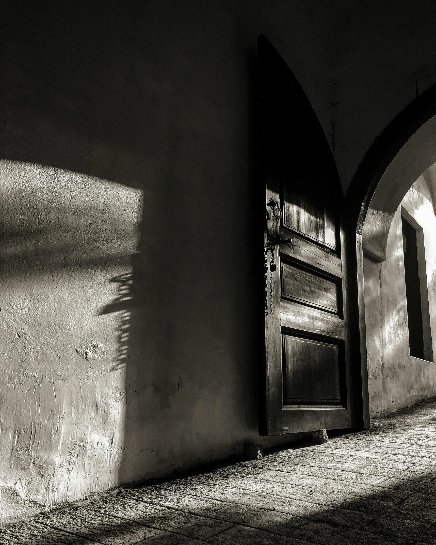 a narrow street with a small door to another area