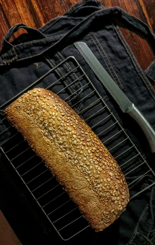 bread on top of a black surface next to a knife