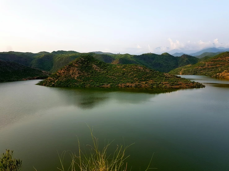 the view of a large lake surrounded by mountains and trees