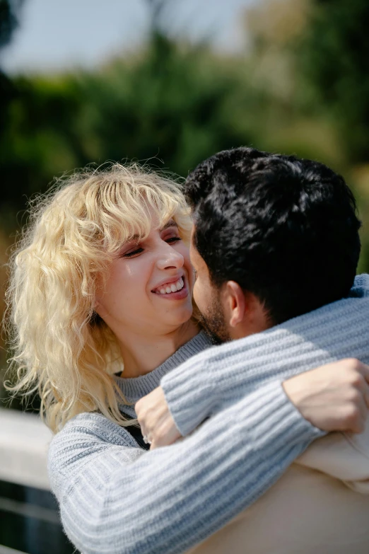 a woman emcing a man while looking away