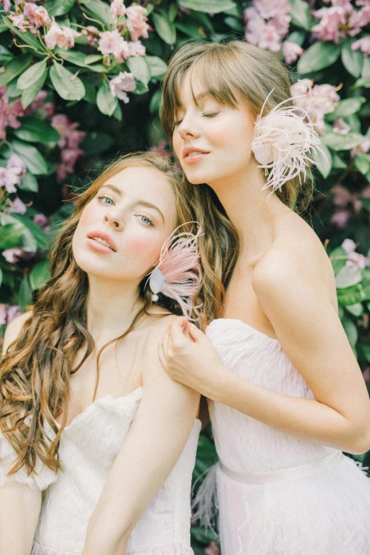 two women dressed in white sitting next to each other