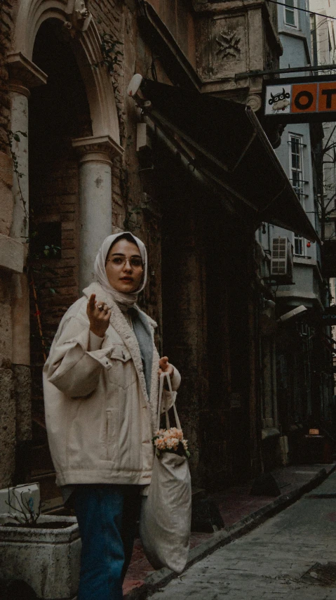 a woman standing in front of an old fashioned building