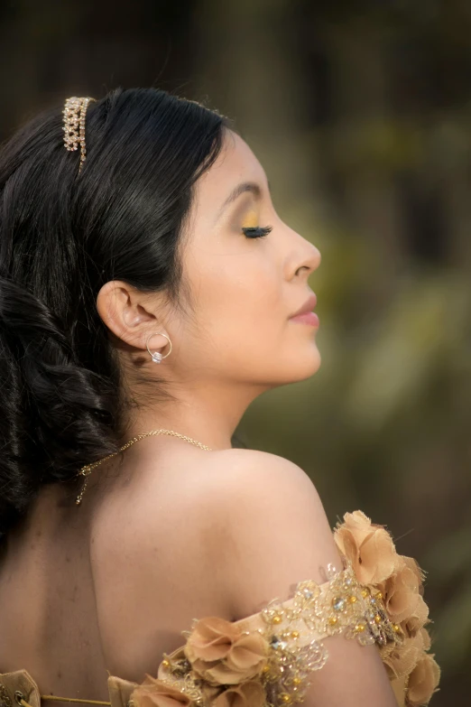 an elegant young lady with black hair wearing a yellow dress