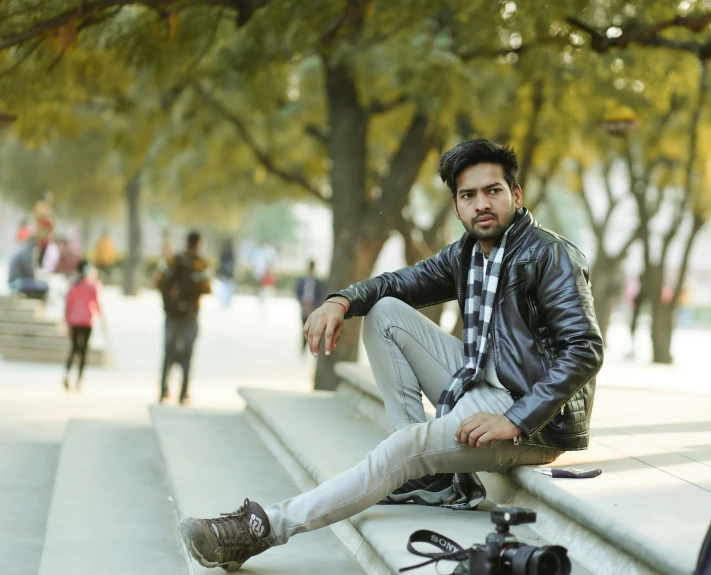 a young man sitting on steps by himself