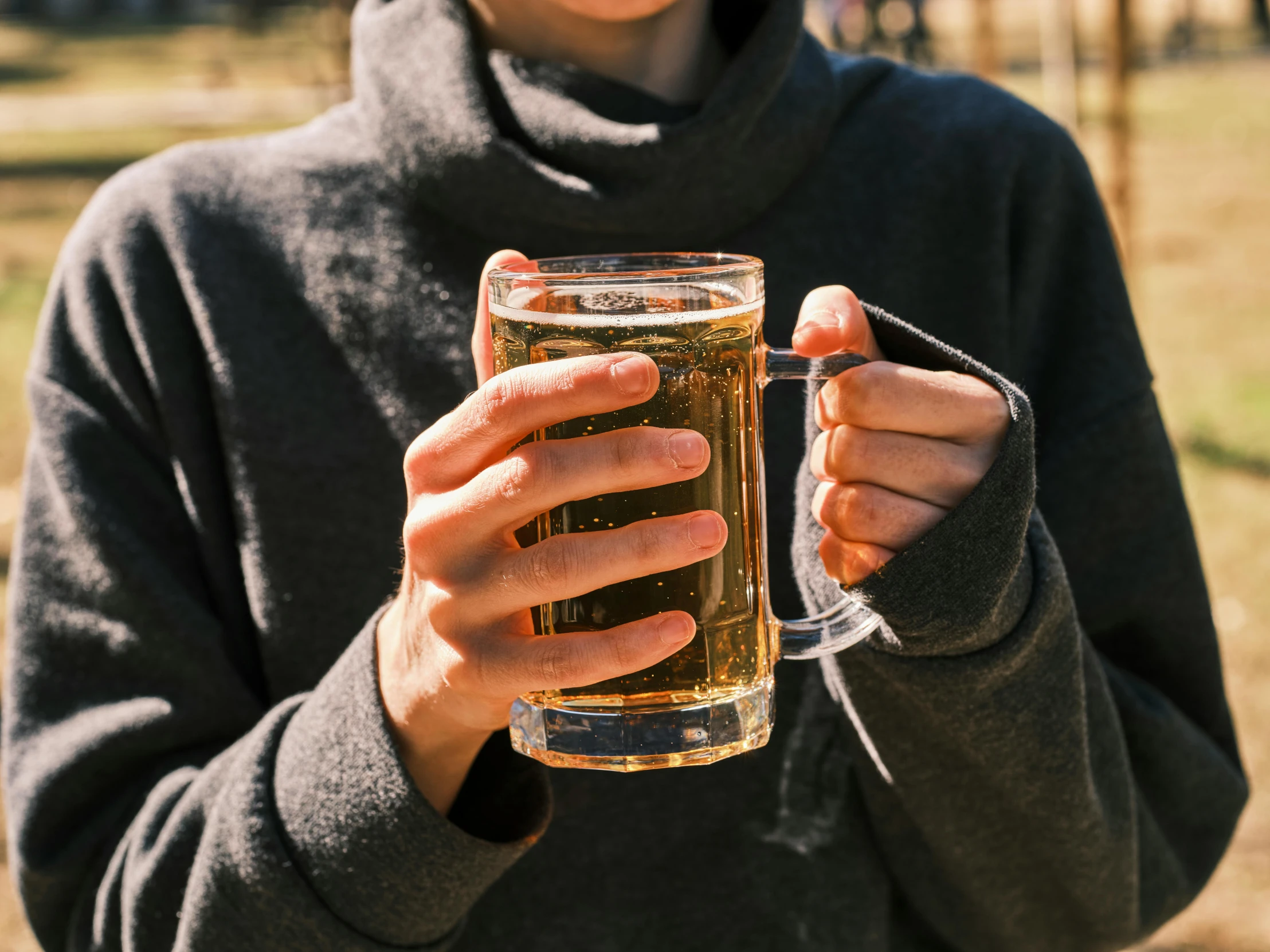 a woman holding up a glass of beer