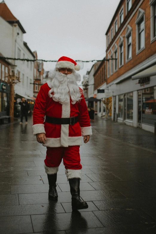 a man dressed as santa claus walking in a city street