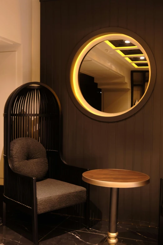 this room features black and gold furniture and a circular mirror