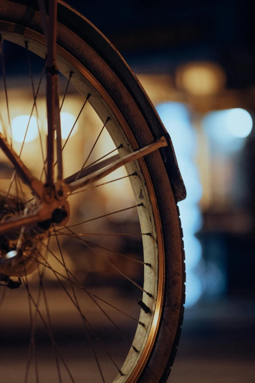 the wheel of a bicycle sitting on top of a sidewalk