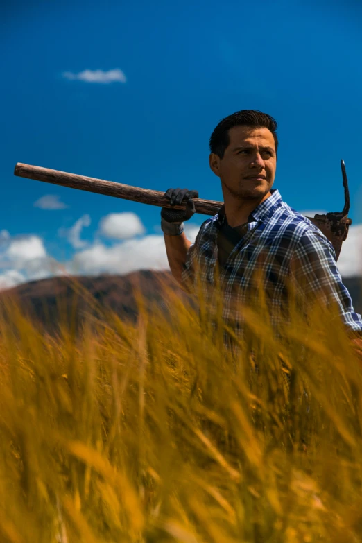 a man is holding a large axe up to his head