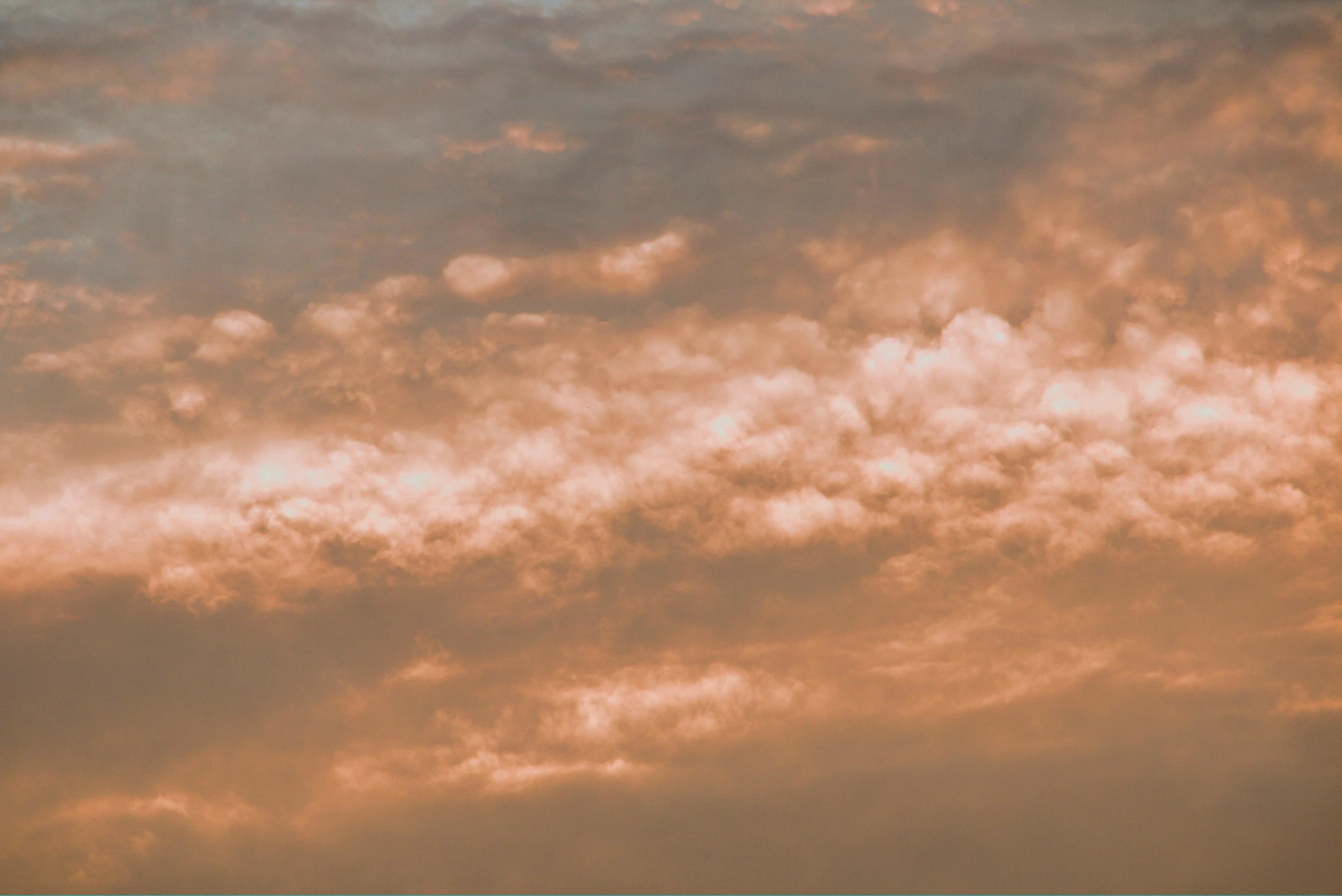 a large jetliner flying in the sky with some clouds