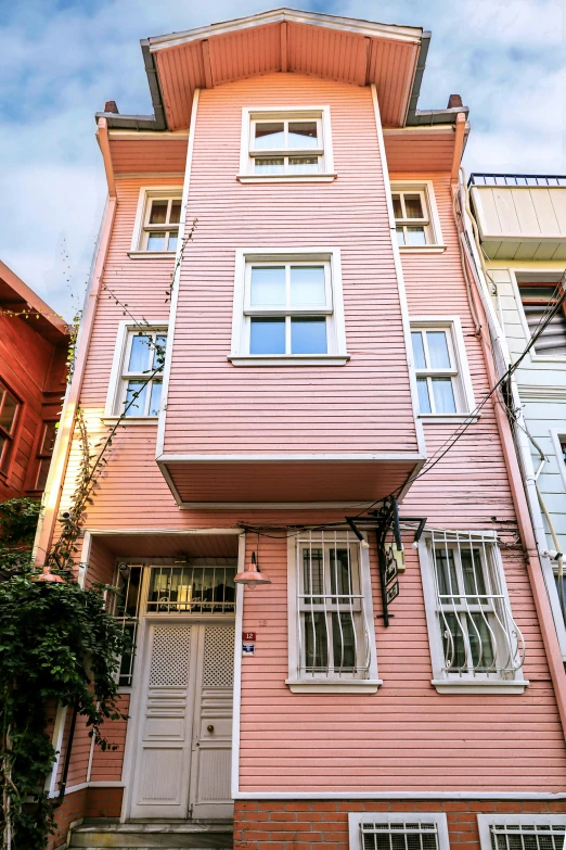 a building with windows that are colored pink