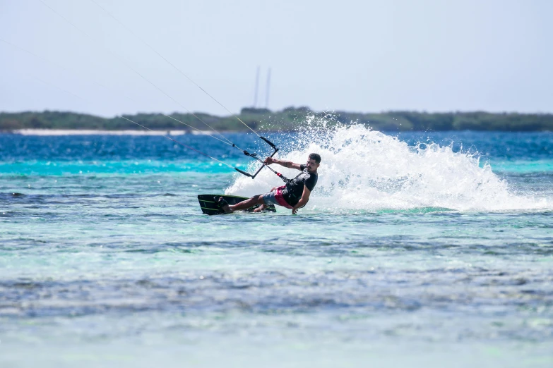 a kite surfer does a flip on the water