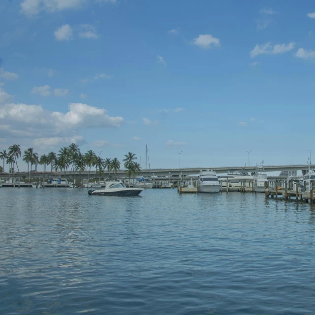 boats are docked on the water beside a pier