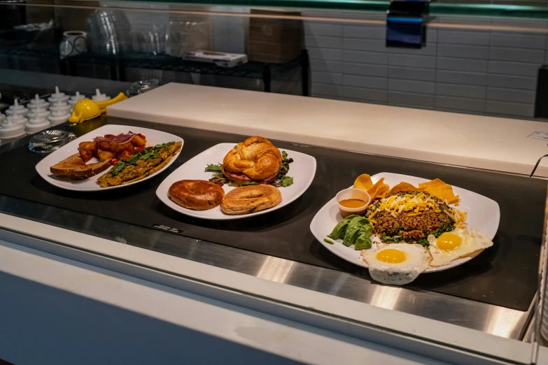 three plates of food that include eggs and pastries