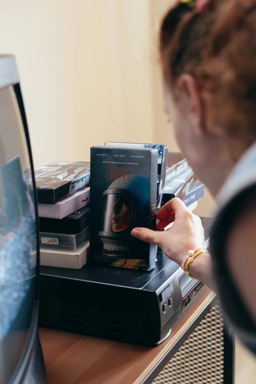 the girl is touching her cd in the mirror