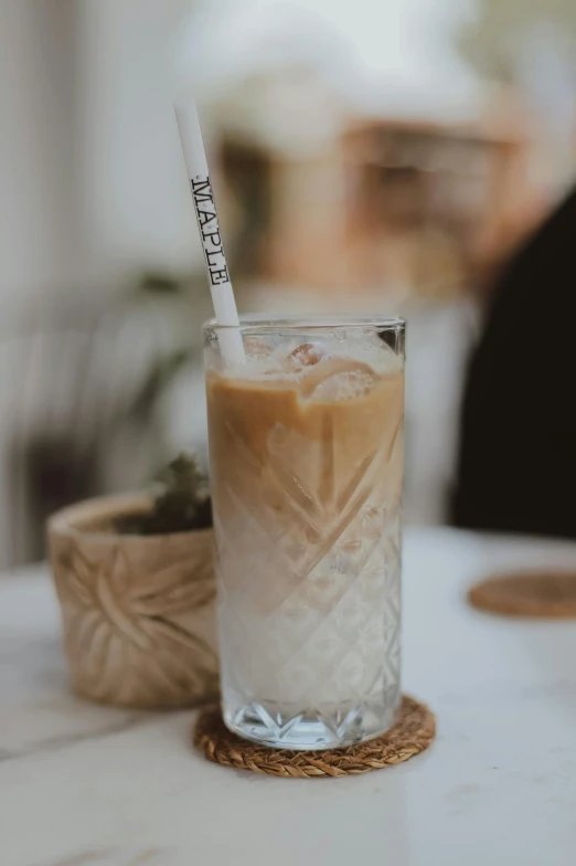 a drink that is on the table next to some plants