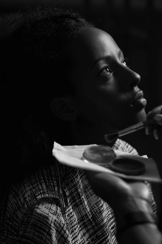 the black and white po shows the girl eating a plate with a spoon