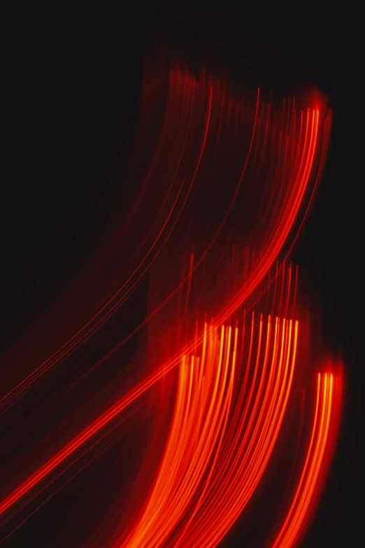 a po taken from the top floor looking down at a dark background, some lights in red and orange streakes are swirling