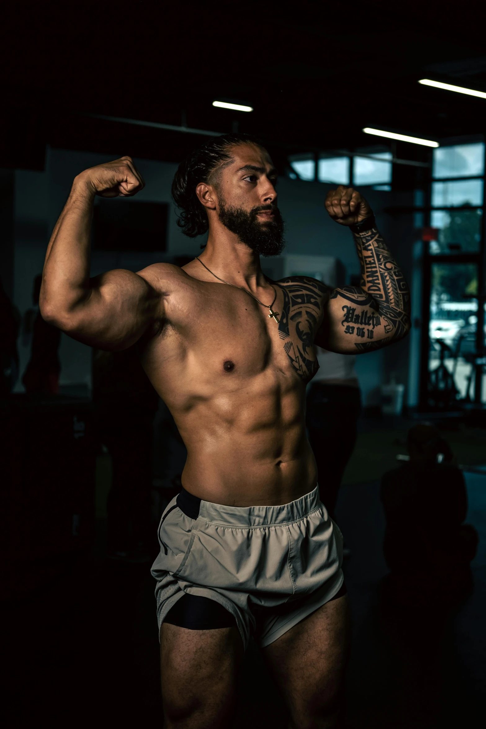 man showing off his muscles in a gym