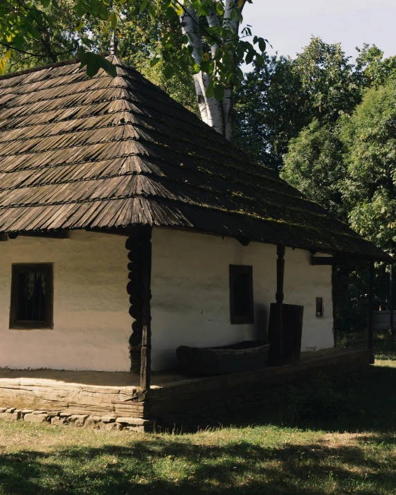 a white house with wooden trim and brown roof