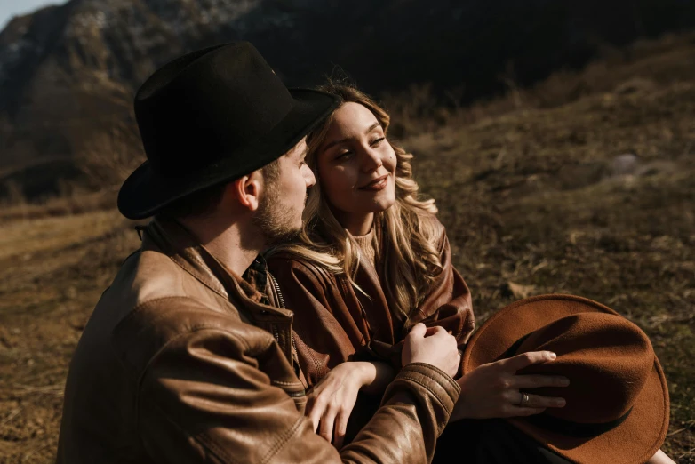 a man and woman are sitting on the ground