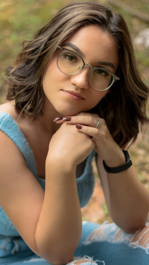 a pretty young lady with glasses and a short dress